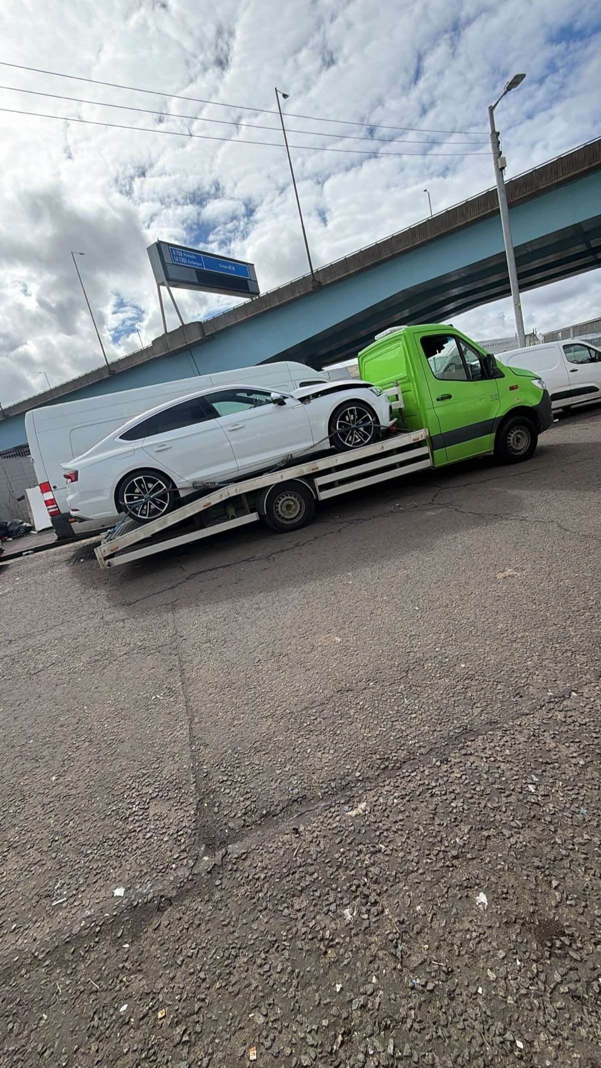 White saloon car being loaded onto SP Rapid Recovery truck for breakdown recovery in Glasgow